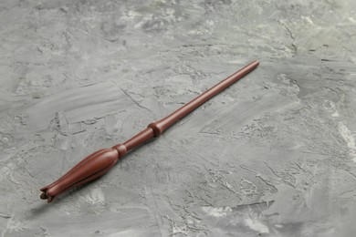 Photo of One magic wand on grey textured table