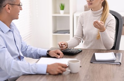 Banker working with client at table in office