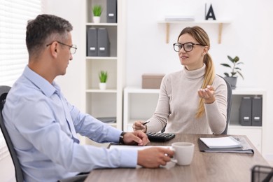 Banker working with client at table in office