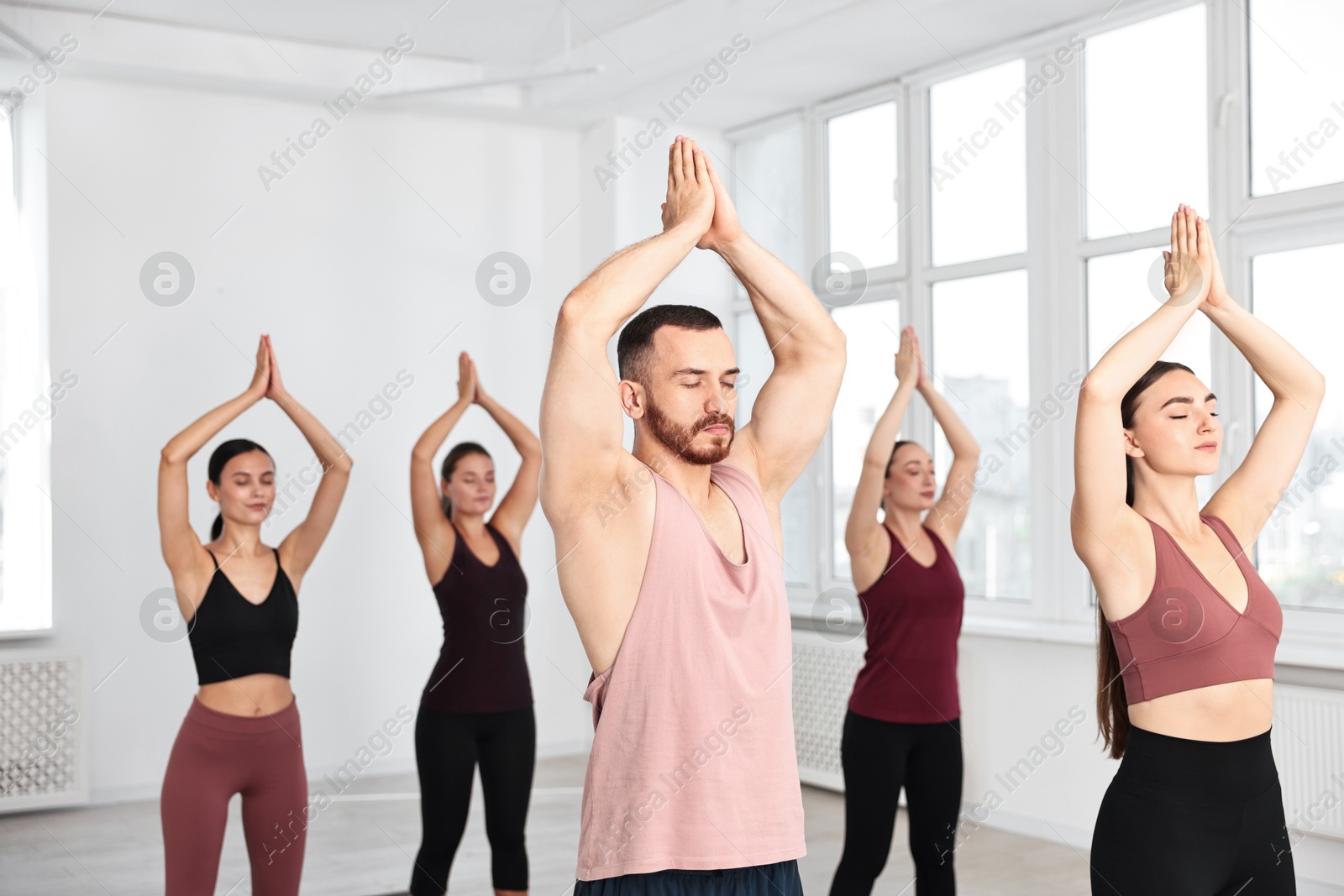 Photo of Group of people meditating in yoga class