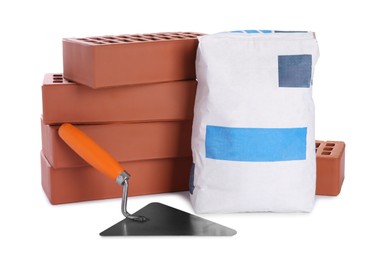 Cement powder in bag, trowel and red bricks isolated on white. Building materials and construction tool