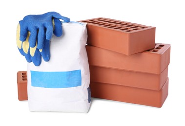 Cement powder in bag, gloves and red bricks isolated on white. Building materials