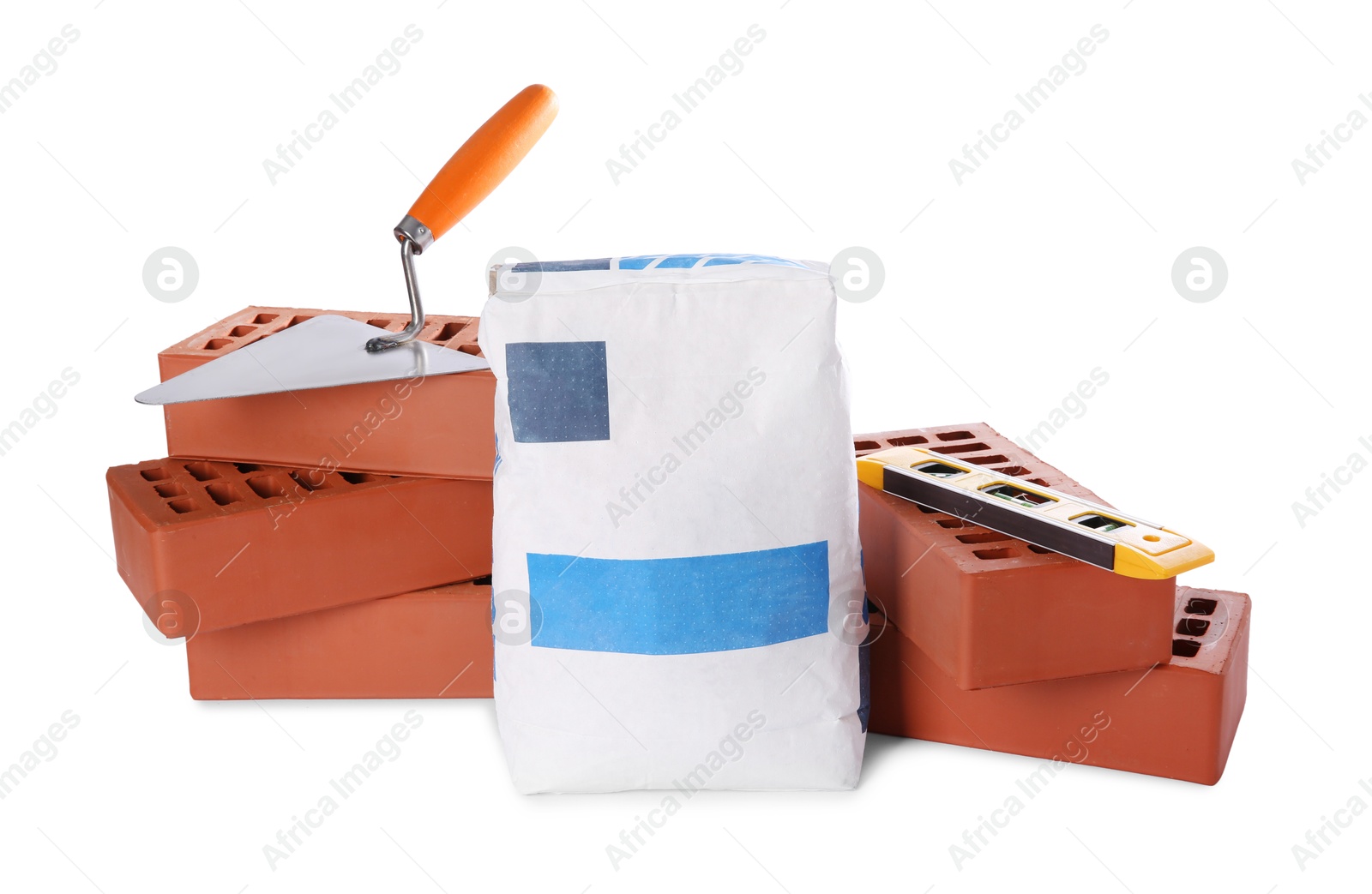 Photo of Cement powder in bag, trowel, red bricks and building level isolated on white