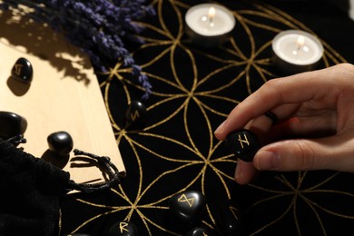 Photo of Woman with rune Hagalaz at table, closeup