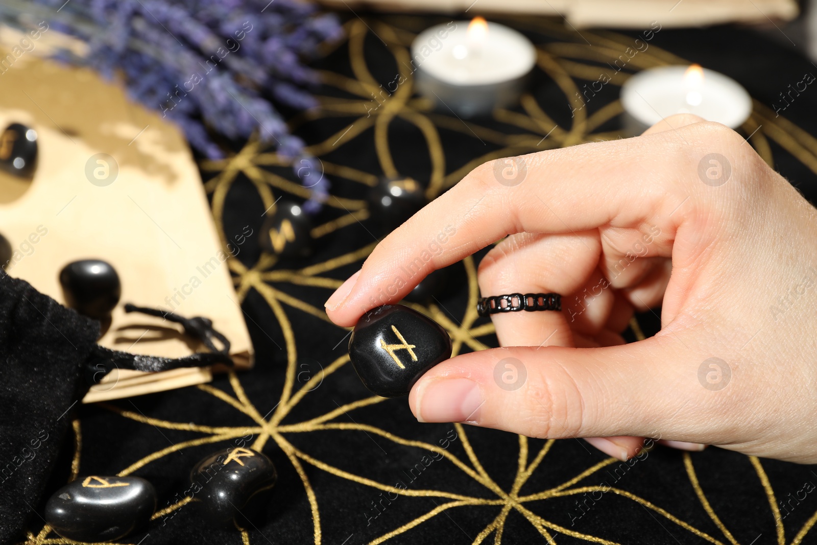 Photo of Woman with rune Hagalaz at table, closeup