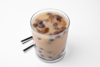 Tasty milk bubble tea in glass and straws on white background, closeup