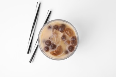 Tasty milk bubble tea in glass and straws on white background, top view