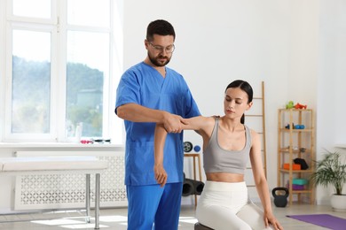 Physiotherapist working with patient in rehabilitation center