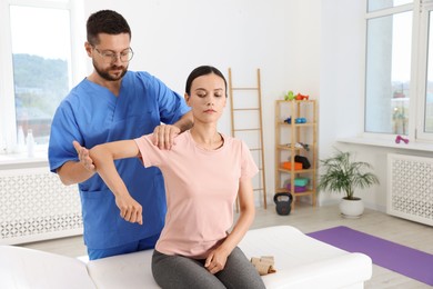 Photo of Physiotherapist working with patient in rehabilitation center