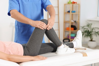 Physiotherapist working with patient in rehabilitation center, closeup