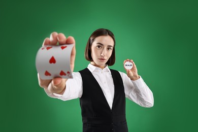 Photo of Croupier with cards and dealer button on green background