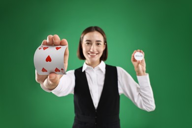 Croupier with cards and dealer button on green background