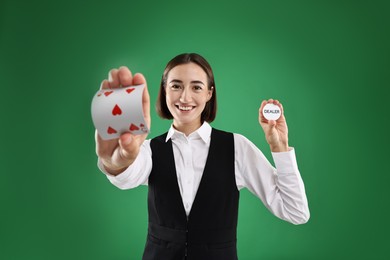 Photo of Croupier with cards and dealer button on green background