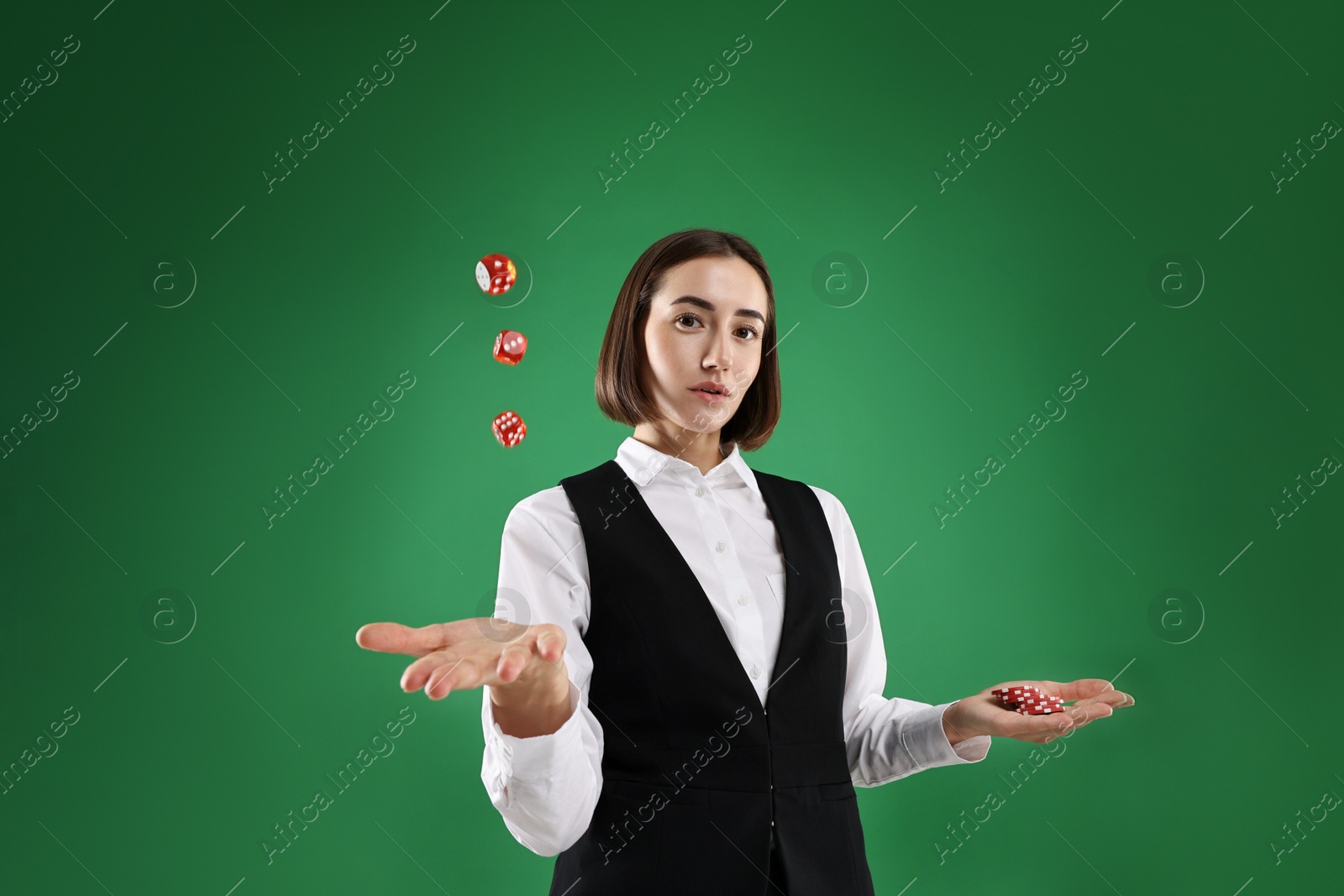 Photo of Croupier with dice and casino chips on green background