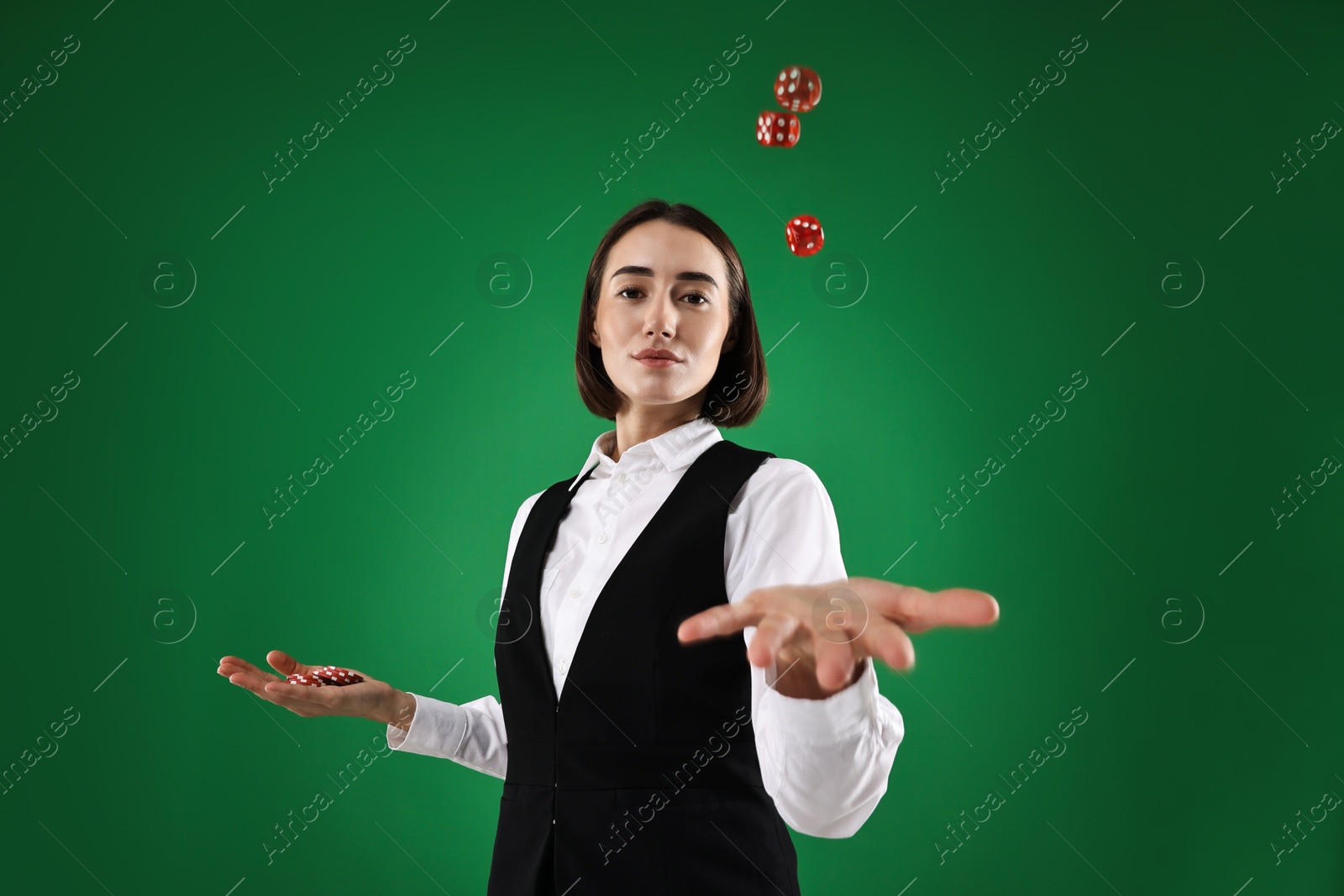 Photo of Croupier with dice and casino chips on green background