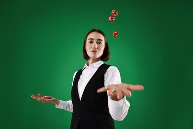 Croupier with dice and casino chips on green background