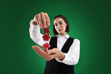 Croupier with casino chips on green background