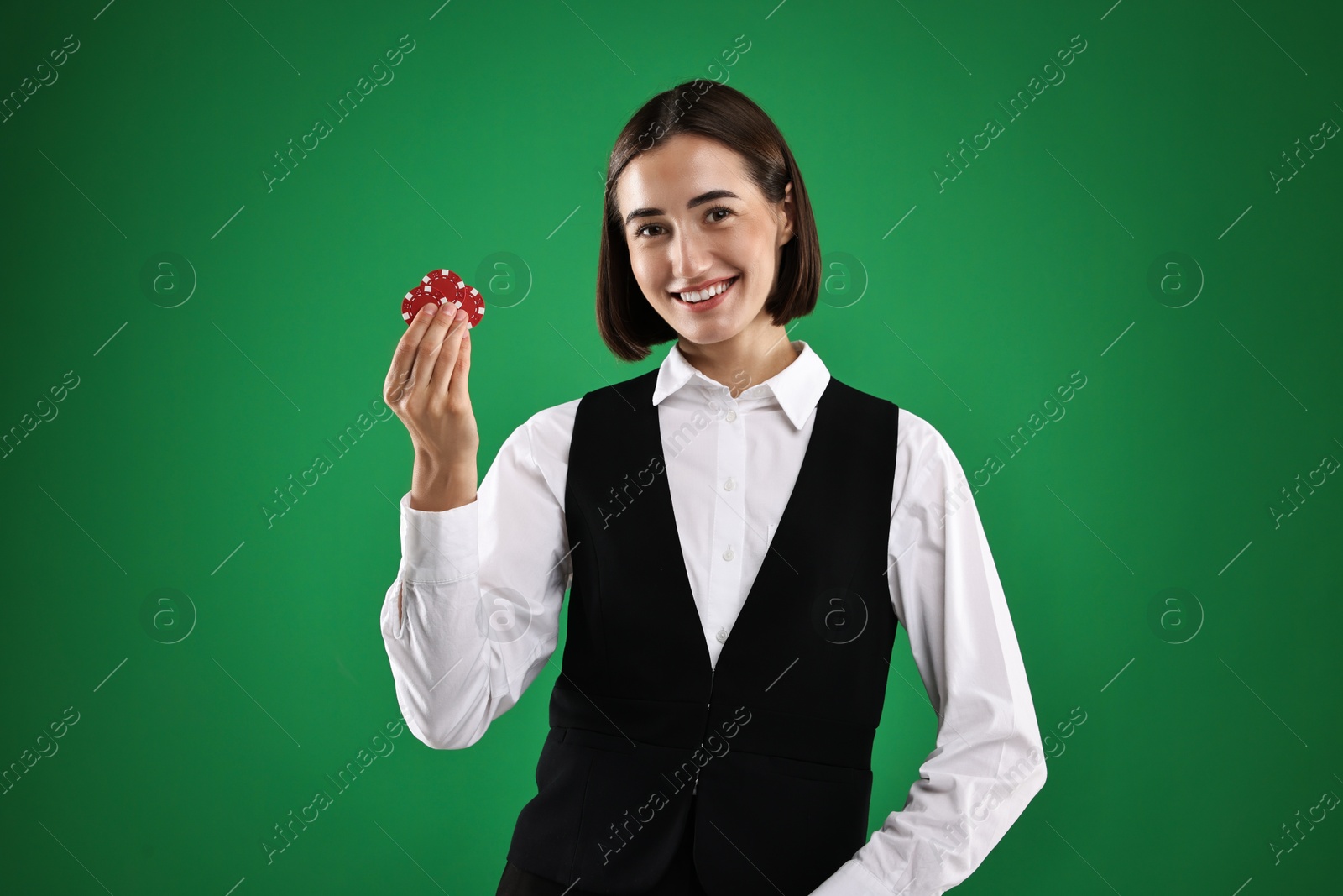 Photo of Croupier with casino chips on green background