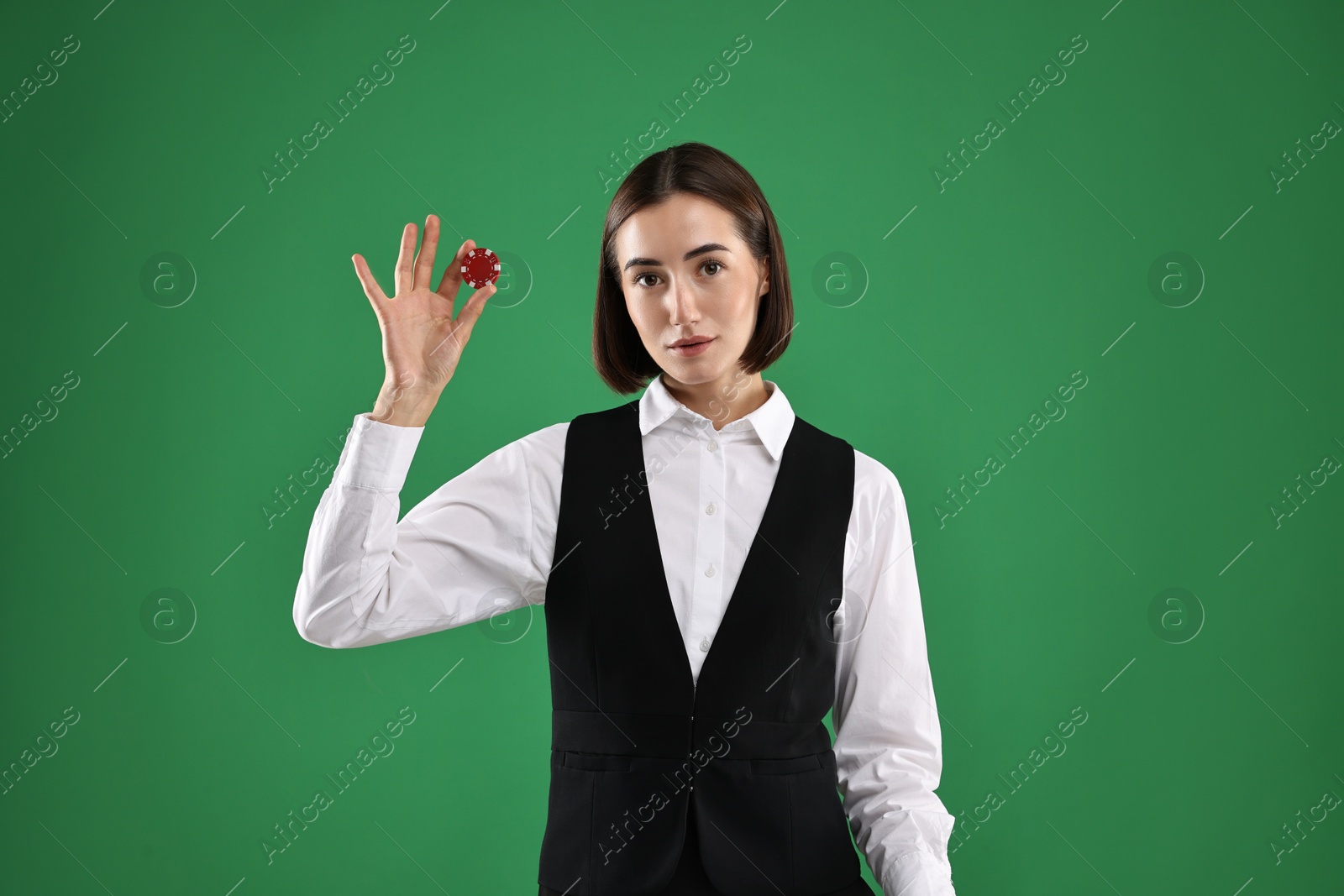 Photo of Croupier with casino chip on green background