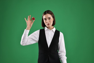 Croupier with casino chip on green background