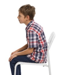 Photo of Boy with incorrect posture sitting on chair against white background