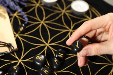 Photo of Woman with rune Nauthiz at divination mat, closeup