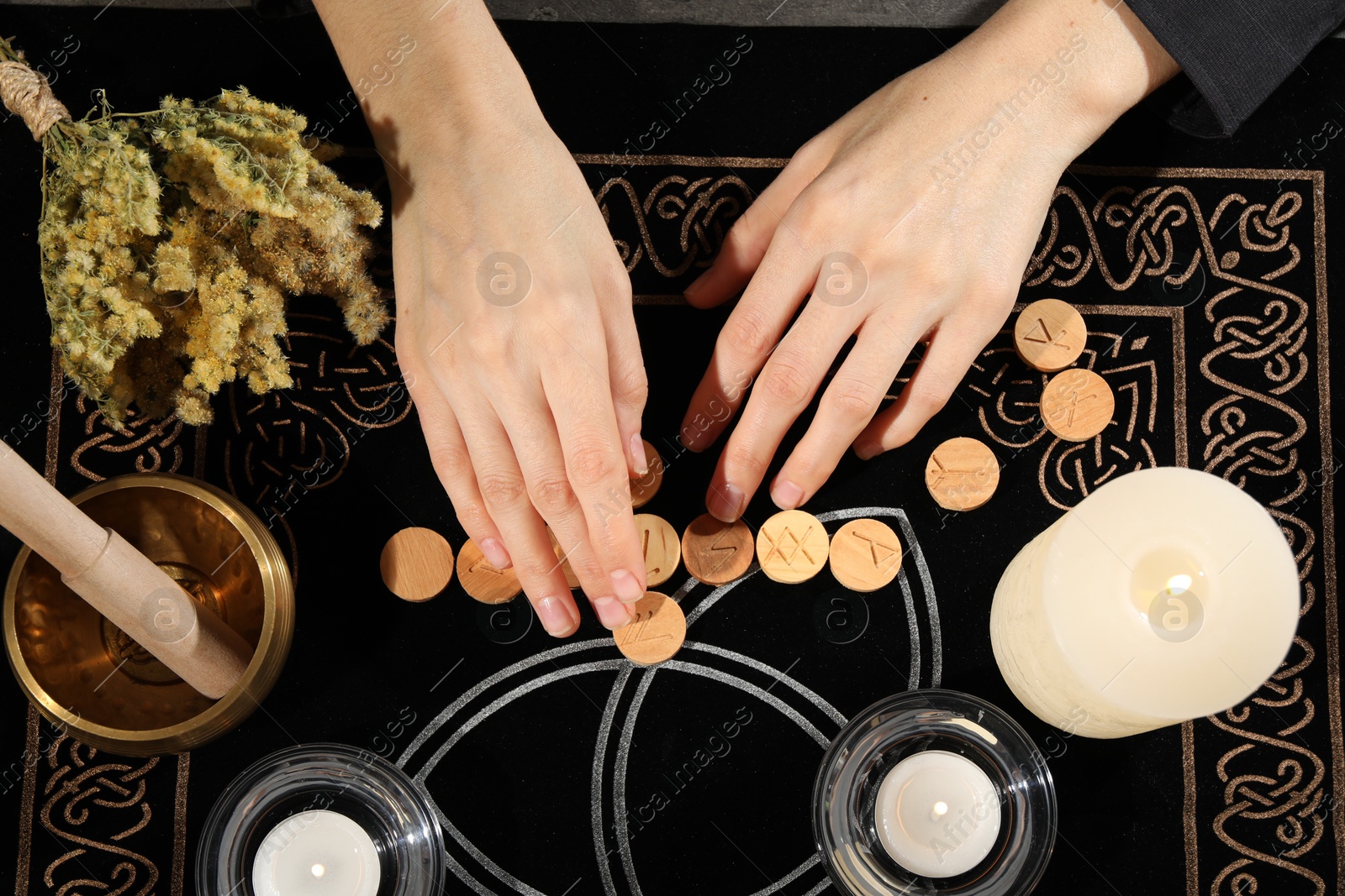 Photo of Woman with wooden runes at divination mat, top view