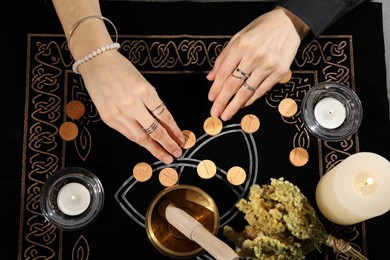 Photo of Woman with wooden runes at divination mat, top view