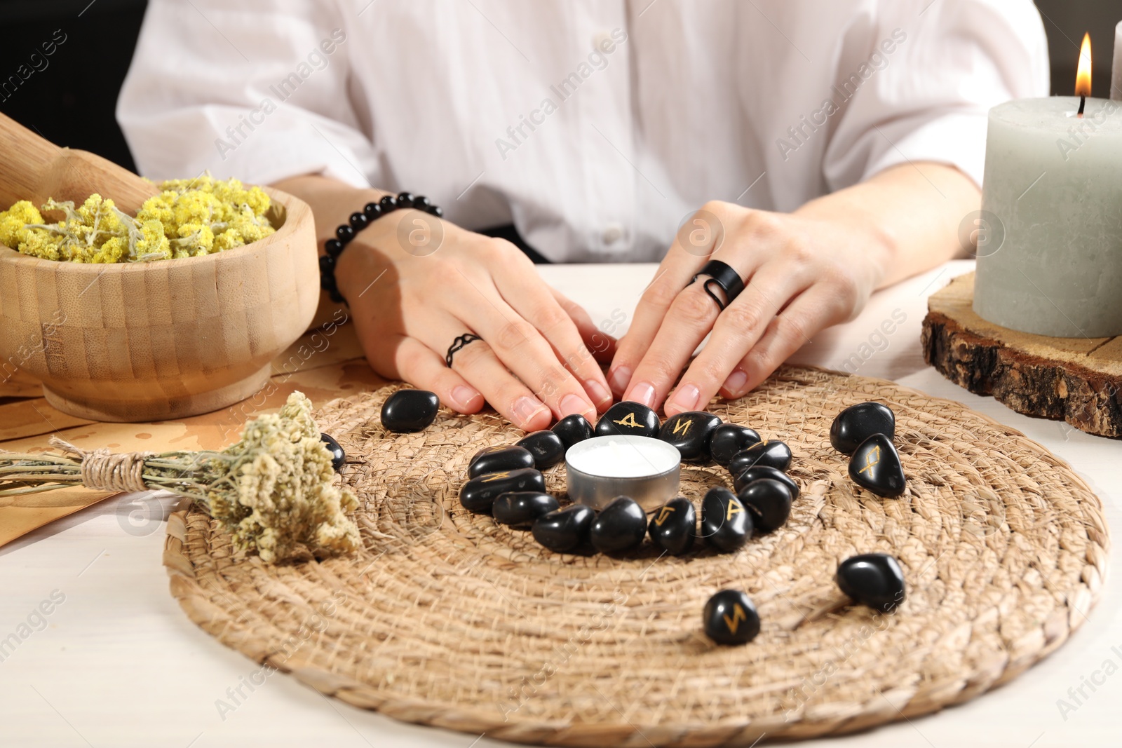 Photo of Woman with black runes at table, closeup