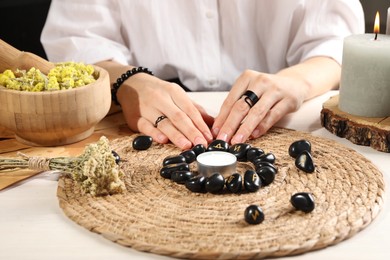 Photo of Woman with black runes at table, closeup