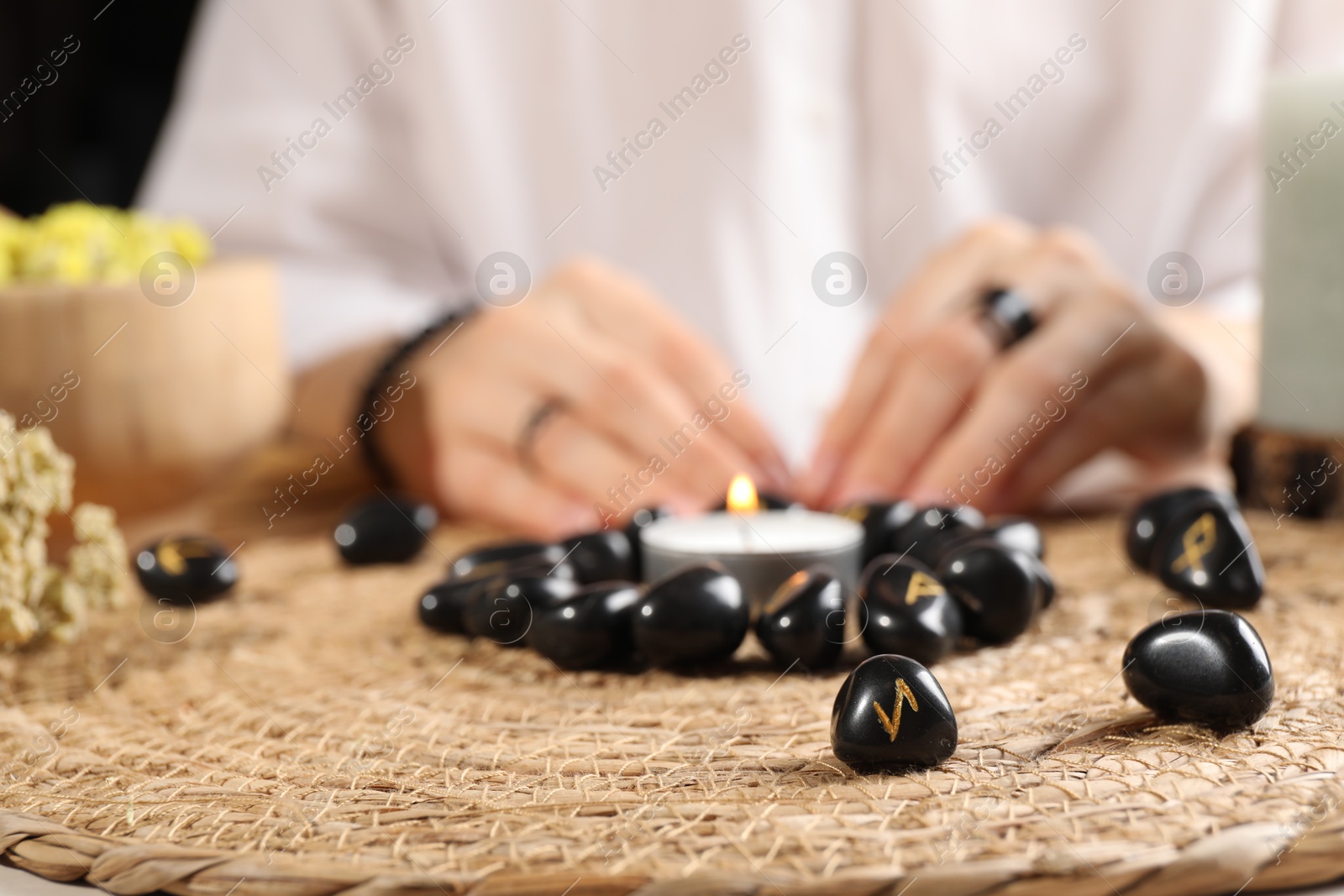 Photo of Woman with black runes at table, closeup