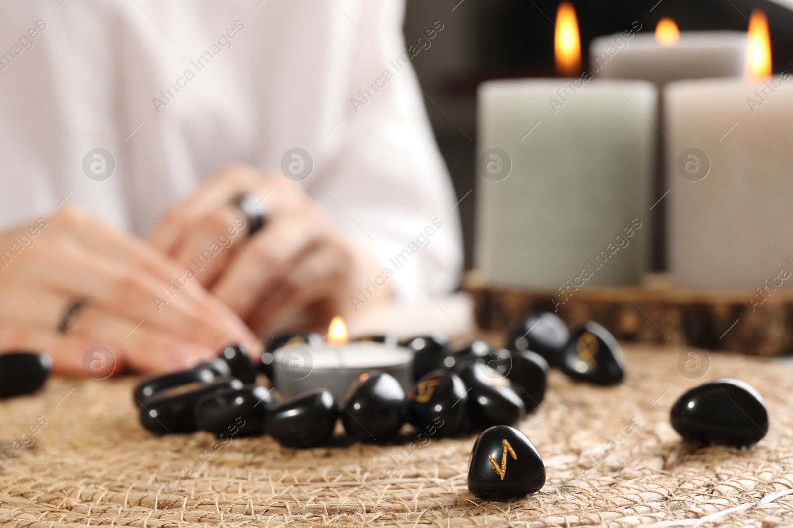 Photo of Woman with black runes at table, closeup