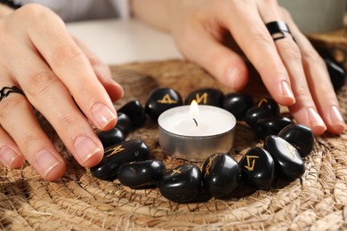 Photo of Woman with black runes at table, closeup