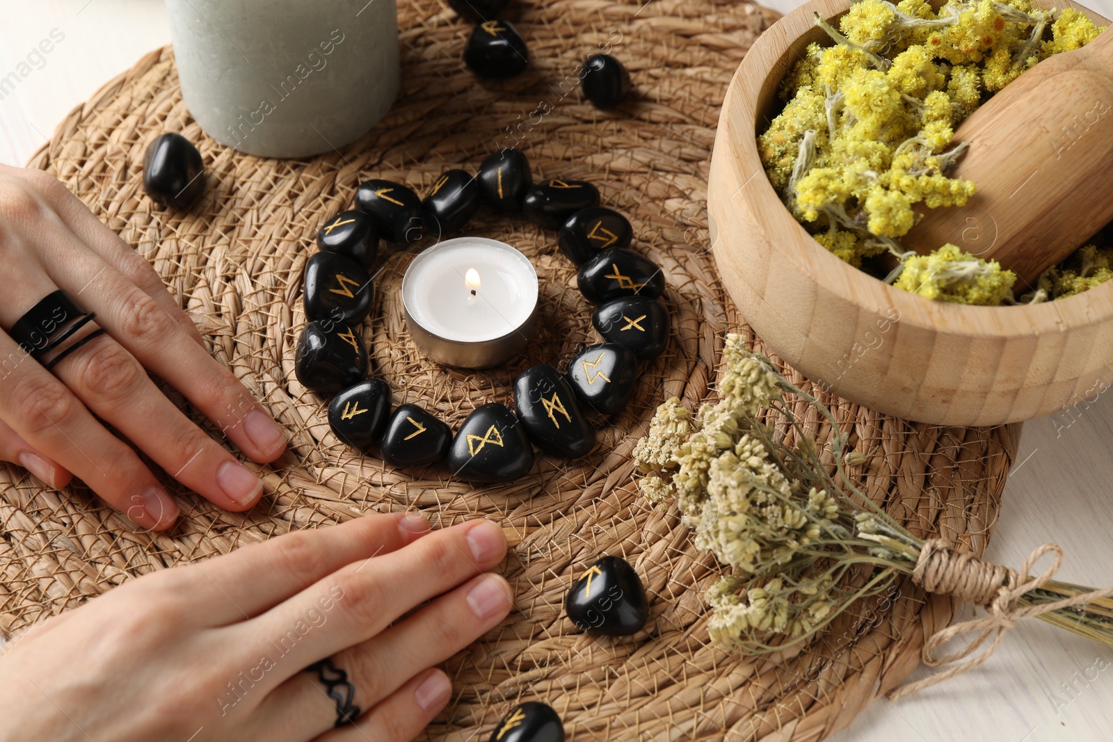 Photo of Woman with black runes at table, closeup