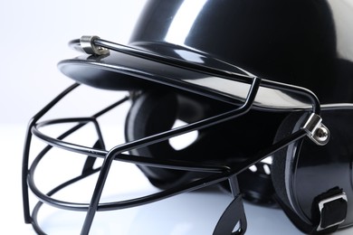 Black baseball helmet on light background, closeup