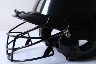 Photo of Black baseball helmet on light background, closeup