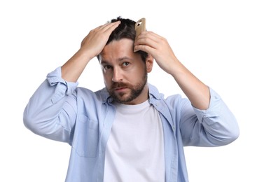 Photo of Man brushing his hair on white background. Alopecia problem