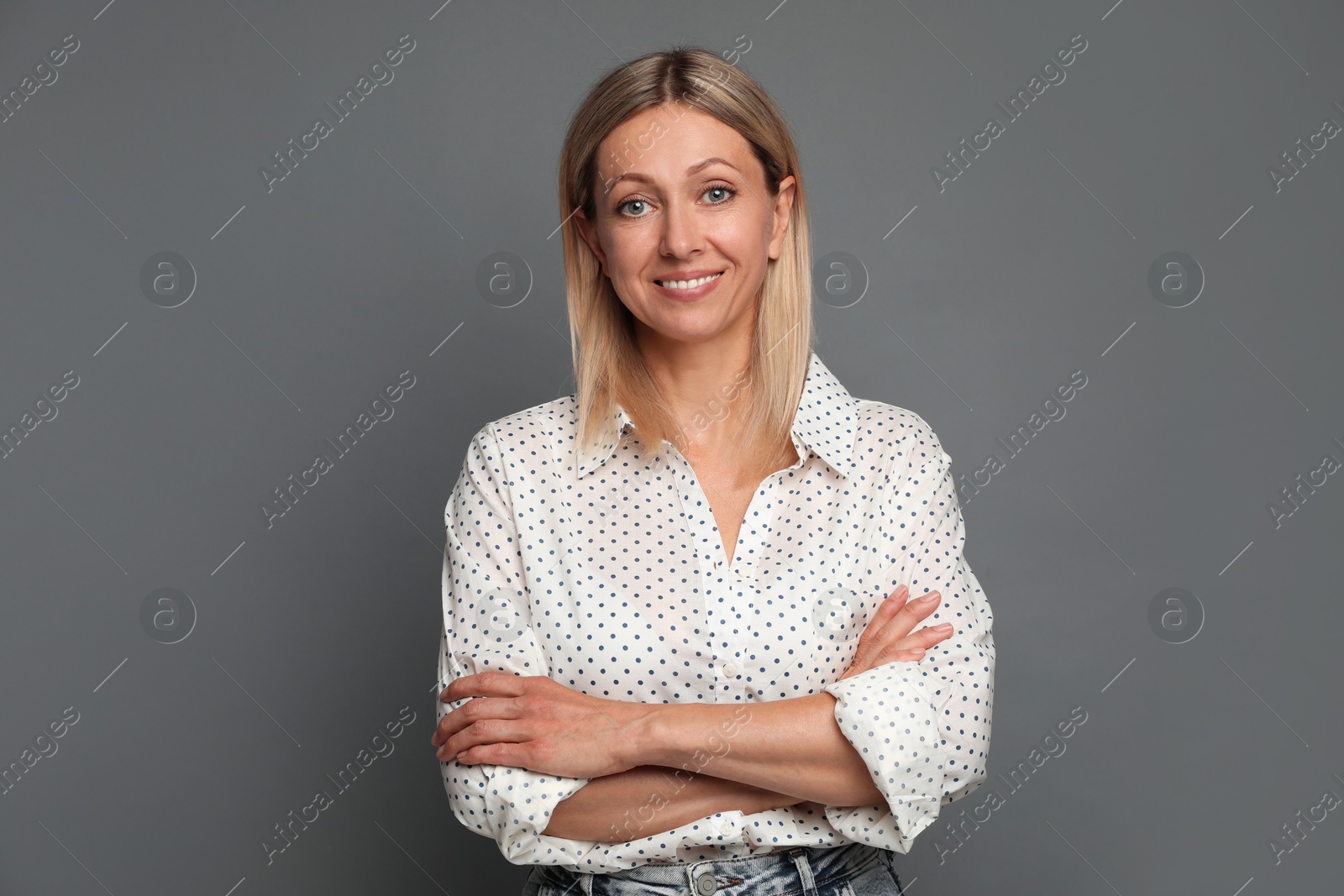 Photo of Portrait of beautiful smiling woman on grey background