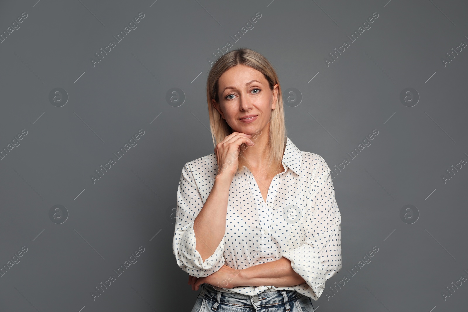 Photo of Portrait of beautiful smiling woman on grey background