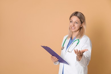 Doctor in medical uniform with stethoscope and clipboard on beige background, space for text