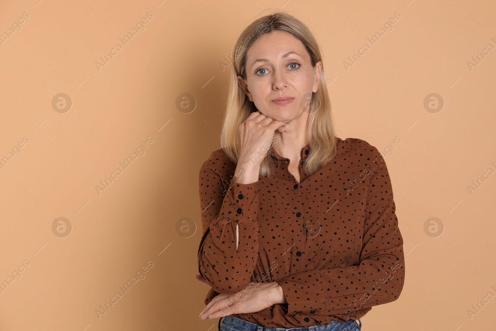 Photo of Portrait of beautiful woman on beige background