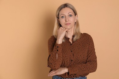 Portrait of beautiful woman on beige background