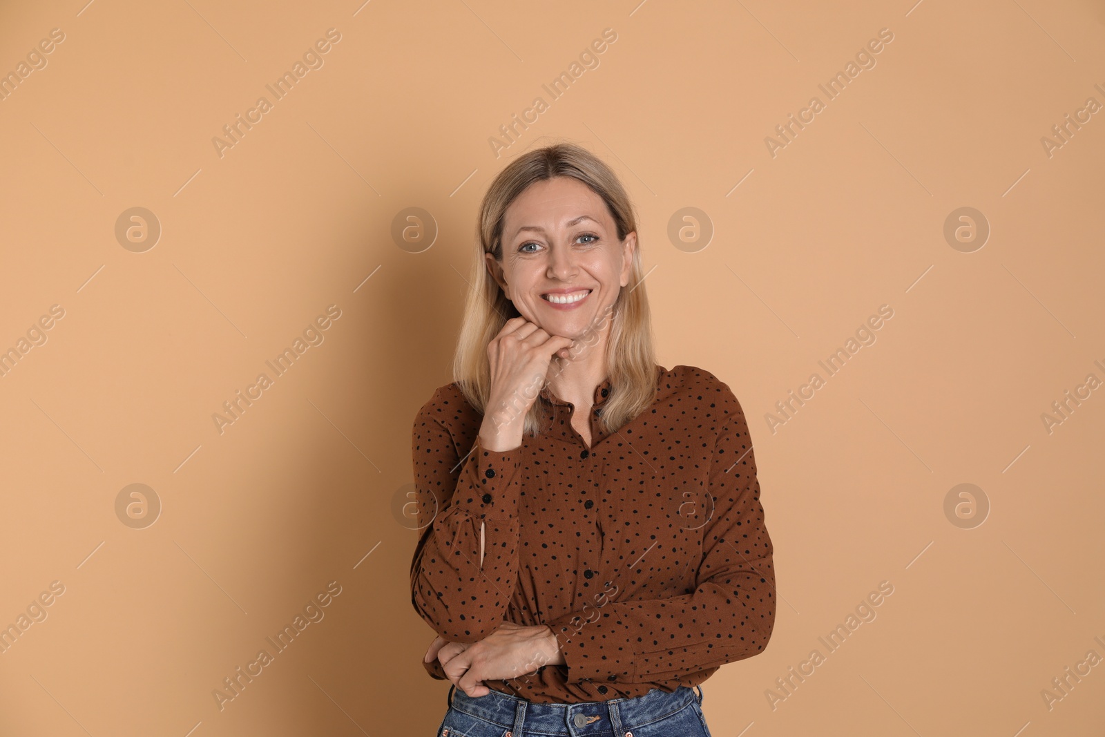 Photo of Portrait of beautiful smiling woman on beige background