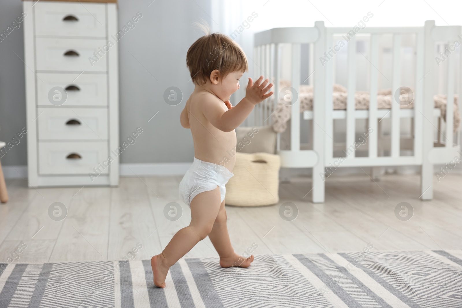 Photo of Cute little child in diaper at home