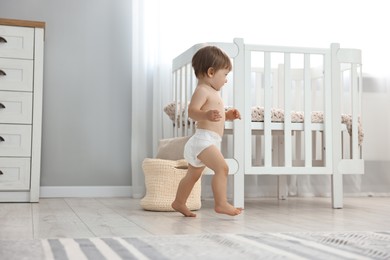 Photo of Cute little child in diaper at home