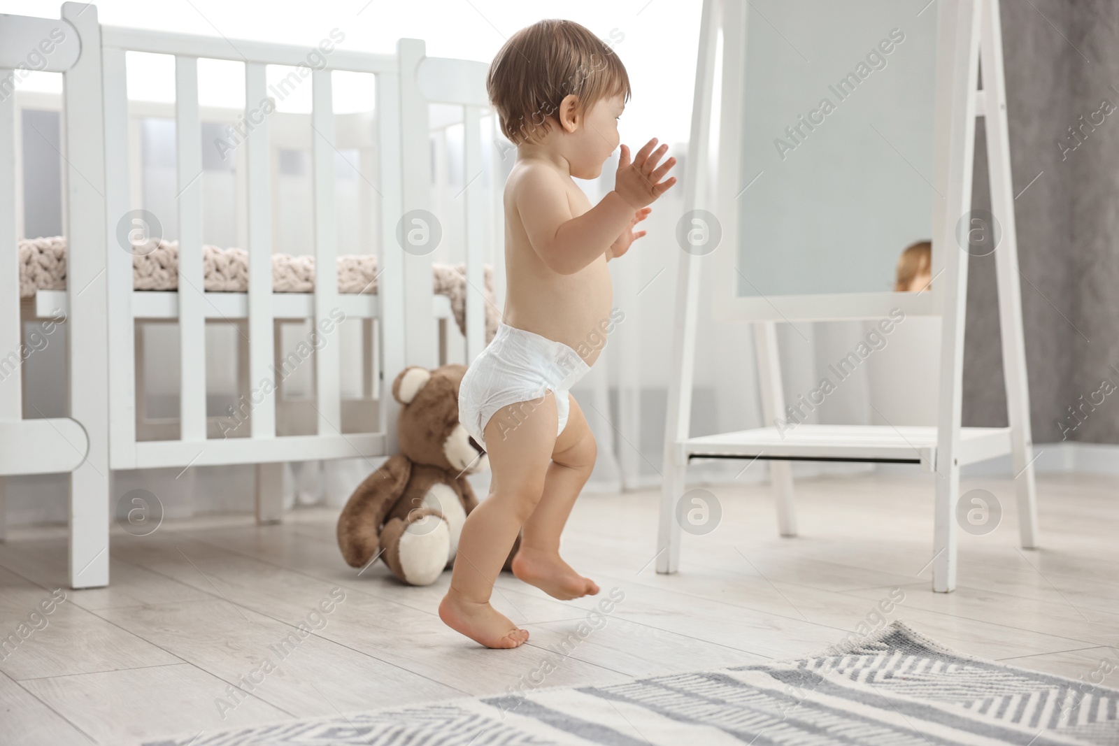 Photo of Cute little child in diaper at home