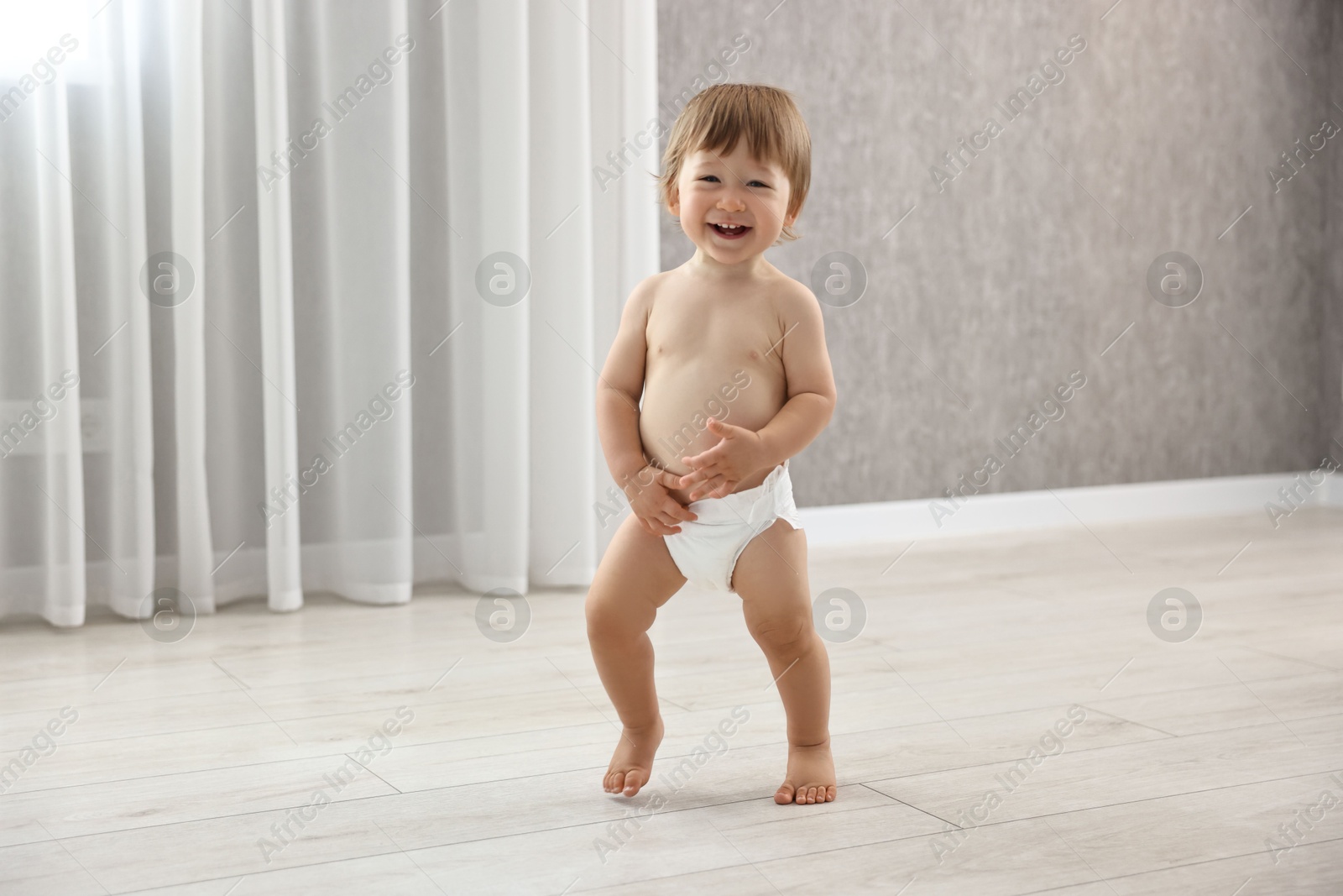 Photo of Cute little child in diaper at home