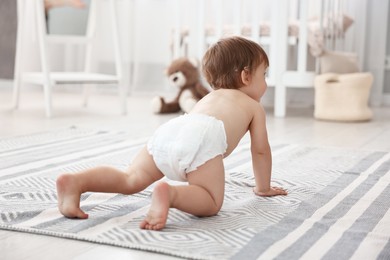 Photo of Cute little child in diaper at home