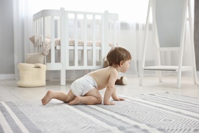 Photo of Cute little child in diaper at home