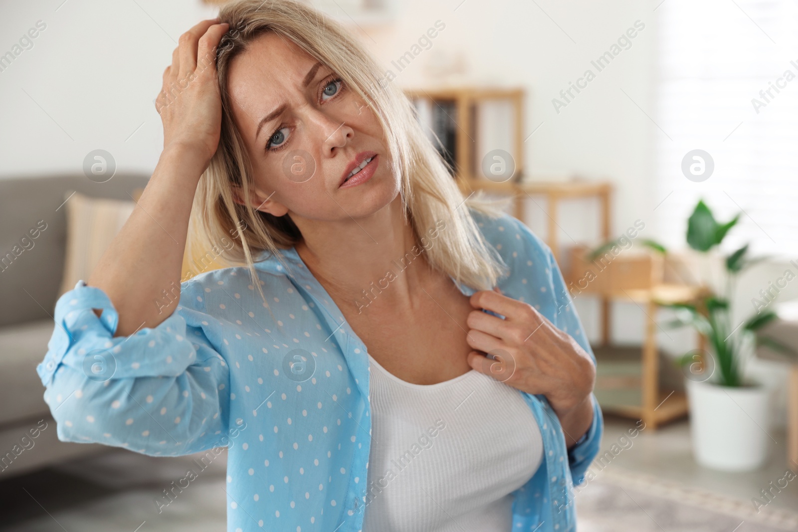 Photo of Menopause. Woman suffering from headache at home